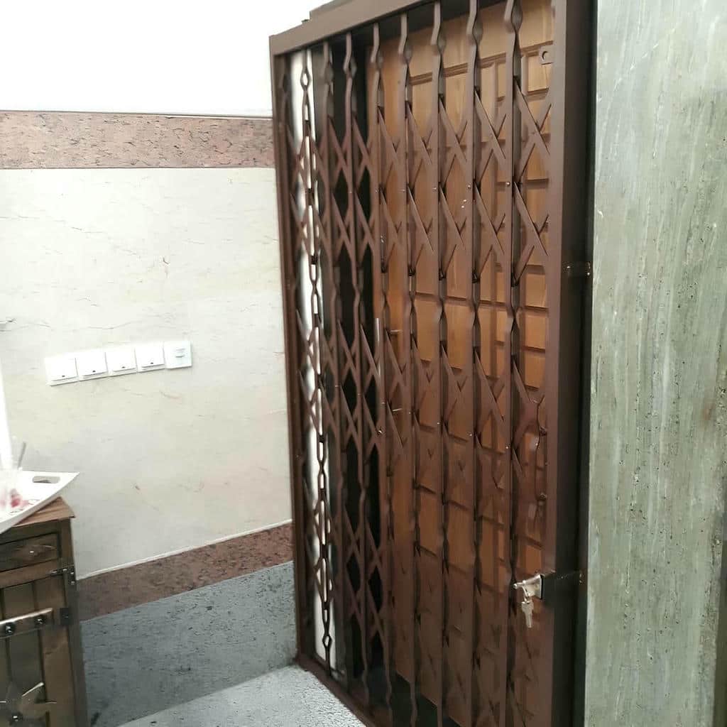 ساخت درب آکاردئونی مدرن مشکی ورودی اداری در یزد با شبکه منظم